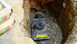 Backwater valve body placed in the basement floor excavation